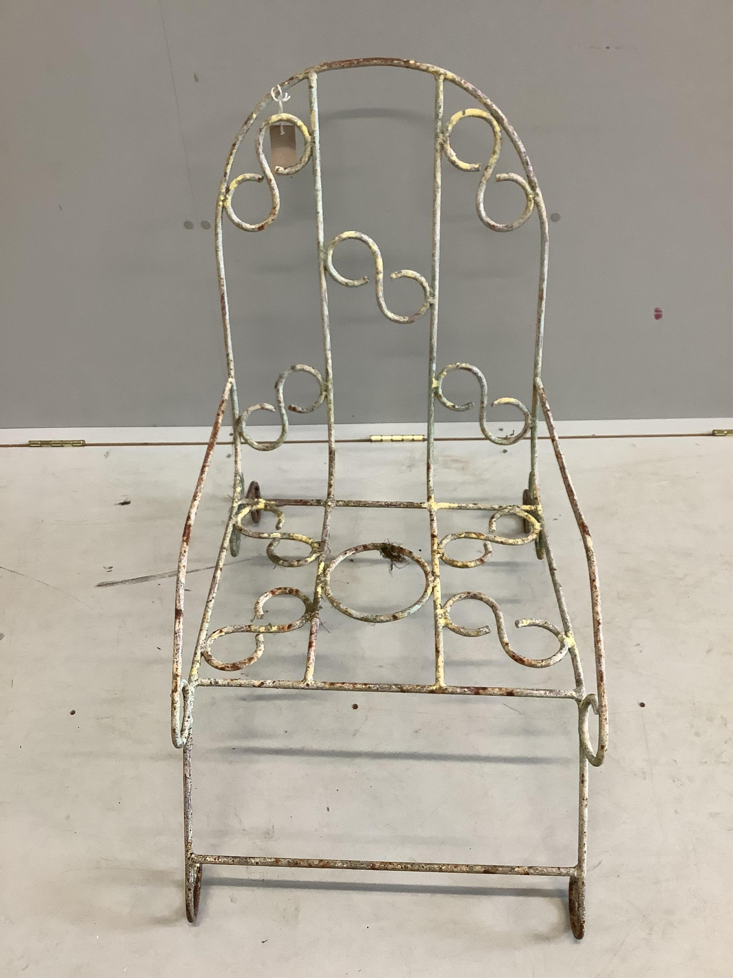 A vintage French wrought iron garden chair, width 48cm, depth 74cm, height 76cm. Condition - fair